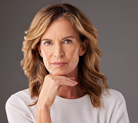 Image showing Face, beauty and skincare with a senior woman looking serious in studio on a gray background. Cosmetics, antiaging and treatment with a mature female pensior posing to promote a health product