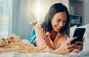 Image showing Happiness, social media and woman on bed with phone, smiling, laughing and relaxing at home. Meme, online and girl on smartphone texting, chatting and browsing internet in bedroom to relax on weekend