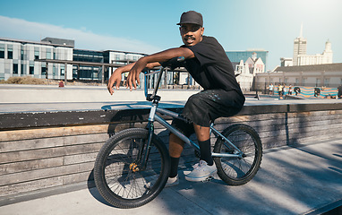Image showing Bike, portrait and man cycling in a park for travel, adventure and sport in the city of Canada. African person training with a bicycle in the street for eco friendly and sustainable transportation