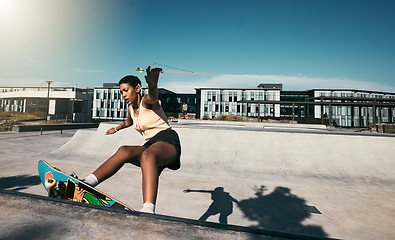 Image showing Fitness, girl and skateboarder skateboarding in a skate park for training, cardio workout and sports exercise. New York, skater and urban city black woman skating outdoors in summer for practice