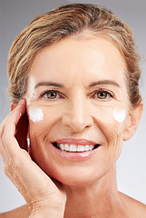 Image showing Mature woman, sunscreen or face cream skincare routine on studio background in facial wellness or healthcare or sun protection. Zoom, smile or happy beauty model with spf grooming product or collagen