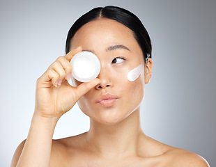 Image showing Face, beauty and skincare with a model asian woman in studio on a gray background to promote a product. Wellness, luxury and facial with an attractive young woman posing for cosmetics or health