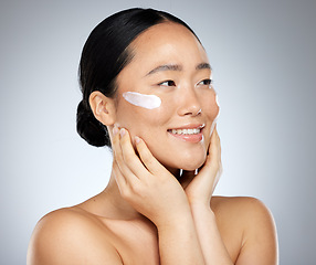 Image showing Asian woman, skincare cream and face makeup, sunscreen beauty product and luxury cosmetics wellness on studio background. Happy Japanese model, facial spf lotion and natural aesthetic dermatology