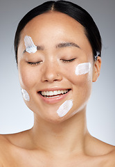 Image showing Beauty, face and skincare with a model asian woman in studio on a gray background for health or wellness. Cosmetics, antiaging and healthy with an attractive young female posing to promote a product