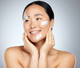 Image showing Woman with sunscreen on face in studio, skincare cream product for natural uv protection and cosmetic wellness. Spa advertising beauty facial, happy korean girl with smile and dermatology spf lotion