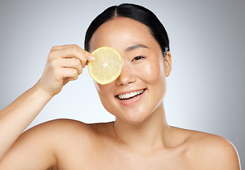 Image showing Lemon skincare, woman beauty and vitamin c natural cosmetics for facial mask, body care and happy results on studio background. Smile Japanese model portrait, organic fruit dermatology and clean face