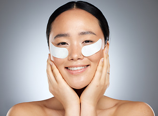 Image showing Skincare, beauty and collagen eye mask on woman from Japan for cooling and anti aging skin treatment for youth. Luxury spa facial, natural product for eyes and smile on face of beautiful asian girl.