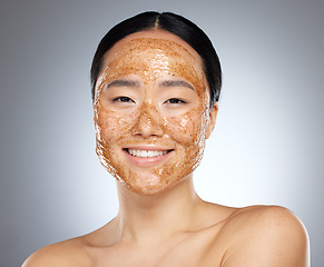 Image showing Woman with face mask, korean skincare spa with natural sugar scrub product or portrait in gray background studio. Face of happy asian girl, wellness beauty with cleaning exfoliation or facial smile