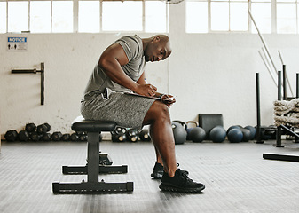 Image showing Gym membership, personal trainer and black man writing on clipboard for exercise, training or workout schedule and program. Male sports coach working on health, wellness and fitness plan or goals