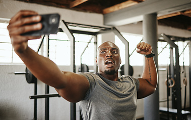 Image showing Gym selfie, smartphone and man flexing arm muscle for a post gyming pump bodybuilding exercise for online social media. Black man, fitness workout trainer and bodybuilder training for wellness health