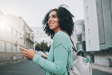 Image showing Happy, black woman and phone for travel in the city of a tourist enjoying sightseeing in an urban street. African American female traveler in communication or navigation on smartphone in South Africa