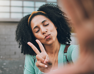 Image showing Selfie, peace and black woman pouting in the city for social media, internet or a mobile app. Young, trendy and face of an African girl with photo smile, fashion and hand sign for the web online