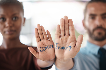 Image showing Hands, gender equality and unity with a sign message on the hand of a business man and woman in the office. Team, diversity and empowerment with a male and female employee standing in solidarity