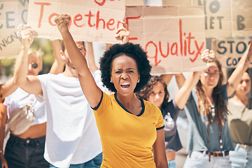 Image showing Protest, crowd of people and black woman in the street, fist in air marching for equality, human rights and freedom. Diversity, protesting and woman shouting for justice in city with cardboard signs