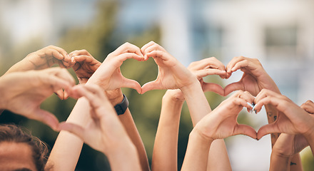 Image showing Hand, heart and love with a group of people making a sign with their hands outdoor together in the day. Crowd, freedom and community with man and woman friends doing a gesture to promote health