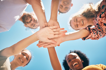 Image showing Hands, friends or support in community collaboration, trust or motivation for goals, success or solidarity. Low angle, huddle or circle of smile or happy people, men or women in diversity celebration