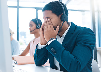 Image showing Stress, customer support and call center employee with a headache in a workplace with headset. Customer service, crm and bored African ecommerce sales man with burnout working in telemarketing office