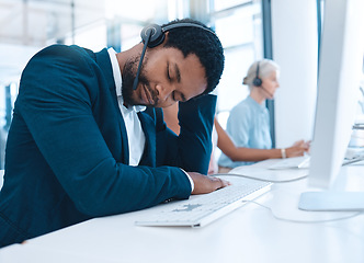 Image showing Call center burnout, sleeping man and employee exhausted after long hours, telemarketing or customer service consulting. Company office agent, help desk consultant or contact us worker tired at work