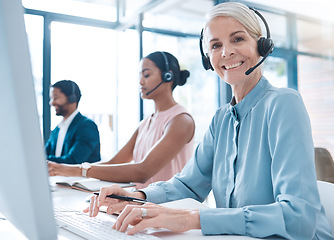 Image showing Portrait of a senior customer support, receptionist or call center agent working online with headset. Expert consultant, crm and ecommerce sales woman telemarketing with computer in corporate office.