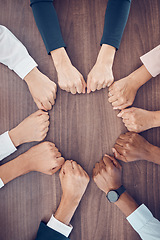 Image showing Top view, business people and fist in support circle, team building or collaboration motivation for success goals or target mission. Men, women or worker hands in huddle on table for diversity growth