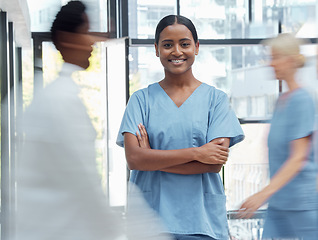 Image showing Medical doctor, nurse or surgeon in a busy hospital, consulting and working in healthcare. Portrait of a happy medicine consultant with pride, arms crossed and happiness at a clinic for service