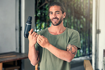 Image showing DIY, drill and home improvement with a man handyman working alone in a home for renovation or improvement. Construction, portrait and maintenance with a male contractor at work with a power tool