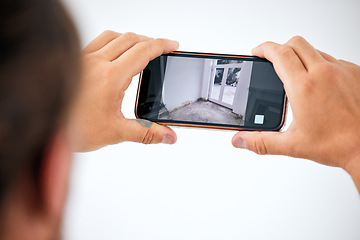 Image showing Surveillance, cctv and smartphone screen in hands for door monitor on wall mock up for trust, safety and home insurance security. Man on cellphone technology app online, live streaming camera system