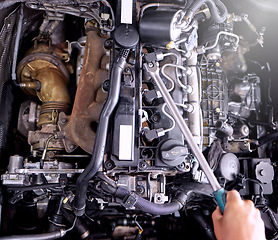 Image showing Car engine in garage, mechanic hands working on auto repair service and inspection of valve with wrench tools. Technician checking machine, f1 industry engineer and diesel motor vehicle performance