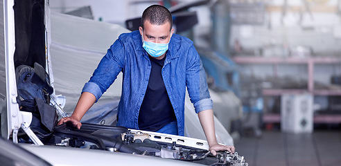 Image showing Mechanic, engine and car, man with face mask for covid safety at auto repair garage, vehicle inspection and maintenance, mechanical engineering. Automobile engineer, car engine check at workshop.