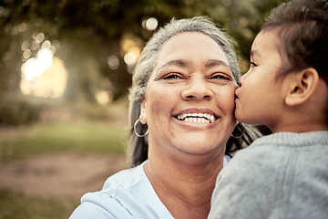 Image showing Happy, child and grandmother with smile and kiss for family quality bonding time together in outdoors nature park. Love, senior woman and kid on carefree summer vacation in a forest with happiness