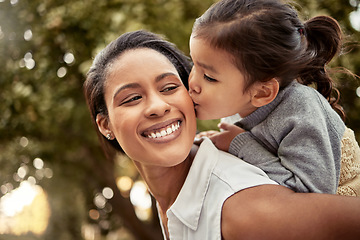 Image showing Child, mother and kiss on piggy back in garden, happy young girl and outdoor adventure in Colombia. Family bonding in backyard, love spring freedom and kid hug mom and playing in park together