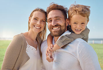 Image showing Park, portrait and happy family love being in nature outdoors to enjoy summer holidays, vacation or weekend. Excited child hugging or piggy backing on a healthy father by his relaxed mother in Sydney