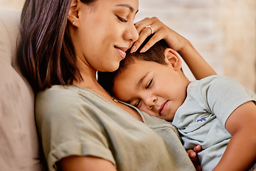 Image showing Cuddle, mother and child with smile on the sofa in the living room for love, peace and relax together in their house. Happy, calm and mom with care and hug for a kid on the couch in their family home