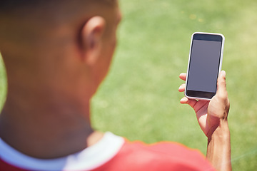 Image showing Man, soccer player and phone on field with screen, blank and mockup on the internet. Man, football player and smartphone on social media, web or app at training, game or sport on pitch at contest