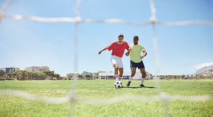 Image showing Soccer, sports and competition with a man athlete and opponent playing a game on a grass pitch. Football, fitness and exercise with a male soccer player and rival running on a field for a workout