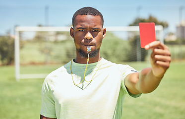 Image showing Red card, soccer referee and whistle for warning, decision and wrong action, foul or penalty on sports field pitch. Football umpire, black man portrait and judge caution soccer player error with sign