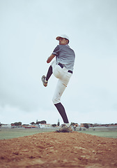 Image showing Man, baseball and pitcher in sports throw or competitive match to score point or win on the field outdoors. Professional baseball player in sport stance ready to pitch the ball in serious competition