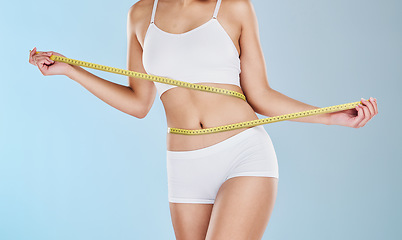 Image showing Health, diet and body of woman with tape measure to track progress, check fitness results and measure waist, stomach or abdomen. Weight loss motivation, wellness lifestyle and slimming self care girl