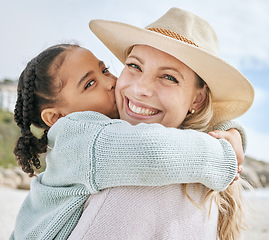 Image showing Beach, holiday and girl kiss mom on her cheek hugging, embrace and holding each other. Love, affection and portrait of mother and child bonding on family vacation by the sea, enjoying summer together