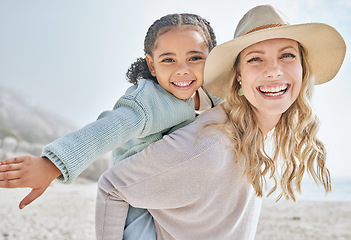 Image showing Beach, foster and portrait with piggy back bonding with black child on California holiday. Adoption, vacation and love in interracial family with happy smile of kid and mom at the ocean.