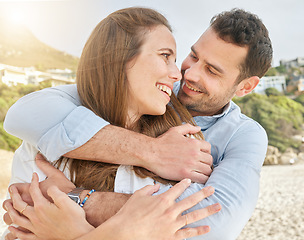 Image showing Love, couple hug on beach and vacation together for international summer travel adventure on white sand coast of Bali. Happy man, woman with smile and relax with peace on holiday hugging by the ocean