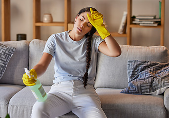 Image showing Spring cleaning, tired and sad woman headache in home living room with burnout, stress and frustrated spray task. Fatigue, pain and depression, housekeeping cleaner and exhausted maid service problem