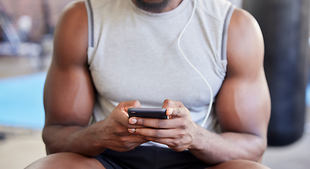 Image showing Fitness, hands and phone in gym with man after workout, training or wellness exercise with social media. Strong, muscular and black man text contact, internet or web app in a health and wellness club