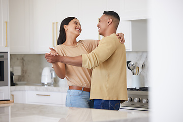 Image showing Love, smile and couple dance in kitchen, celebrating anniversary and bonding. Happy, man and woman dancing, romance and affection, carefree or playful people having fun spending time together in home