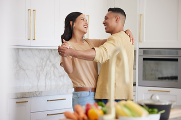 Image showing Couple, love and dancing together in kitchen happy at home bonding, spend time and relax. Young married latin man and woman, romance bonding and having fun laughing or celebrate healthy relationship