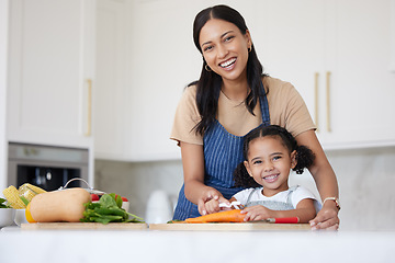 Image showing Happy family, girl or child learning from mother cooking or kitchen skills with healthy organic food vegetables. Smile, development and mom teaching or helping young kid with lunch or dinner at home