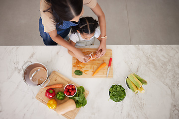 Image showing Cooking, vegetables and mom with child in kitchen cutting, peeling and prepare food. Child development, helping hands and aerial view of mother teaching girl to cook, chef skills and bond together