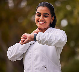 Image showing Pulse, fitness and woman running in the park, on a break to check heart rate on sports watch. Indian girl doing exercise, training and workout in nature for wellness, cardio and healthy lifestyle