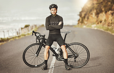 Image showing Man, cycling and mountain bike with arms crossed for sports exercise, training and fitness in nature. Portrait of a confident male professional cyclist standing by a bike for cycle tour outdoors