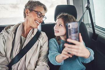 Image showing Travel, phone and selfie with girl and grandmother in car for road trip adventure on vacation for holiday, transportation and social media. Happy, smile and vacation with family for internet post